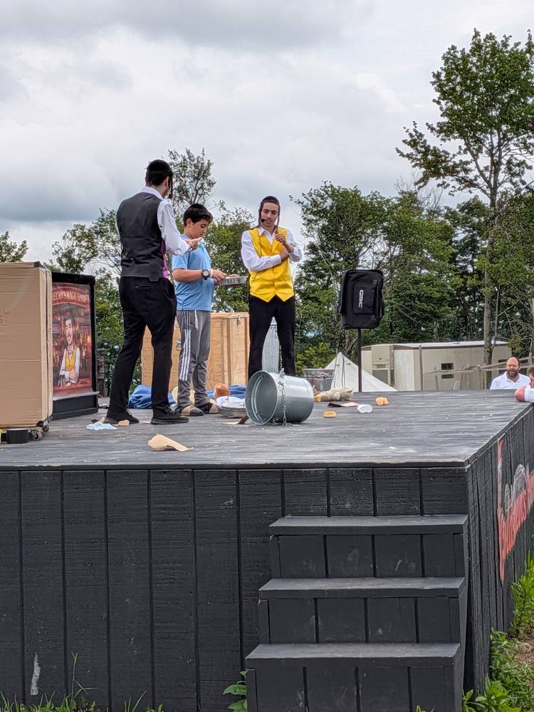 Outdoor stage routine with a volunteer