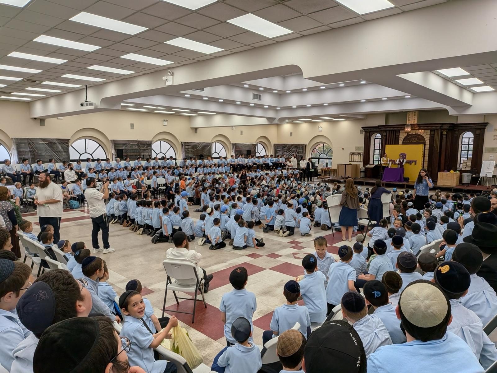 A huge hall full of kids at a show